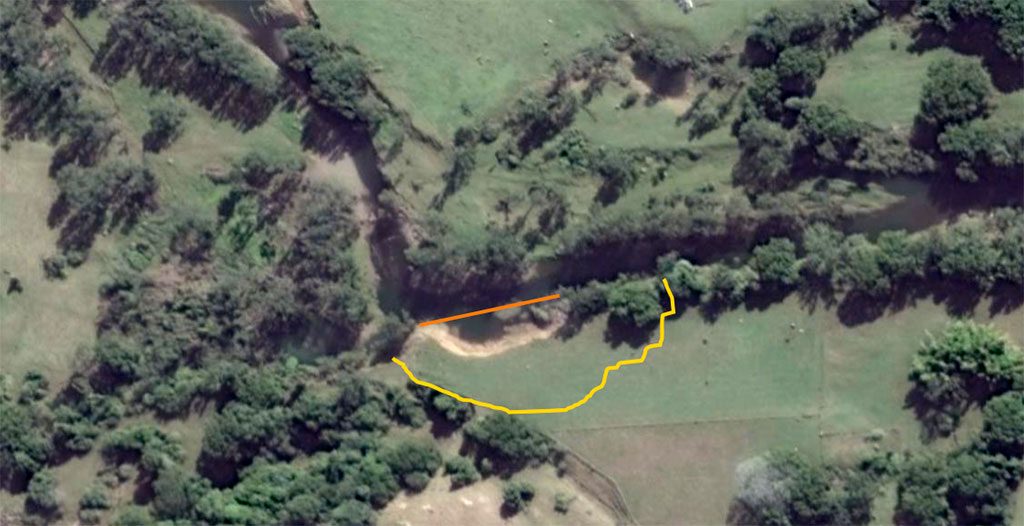 This arial shot shows the beginning of erosion (orange line) and the yellow line indicates the actual loss of land after earthworks.